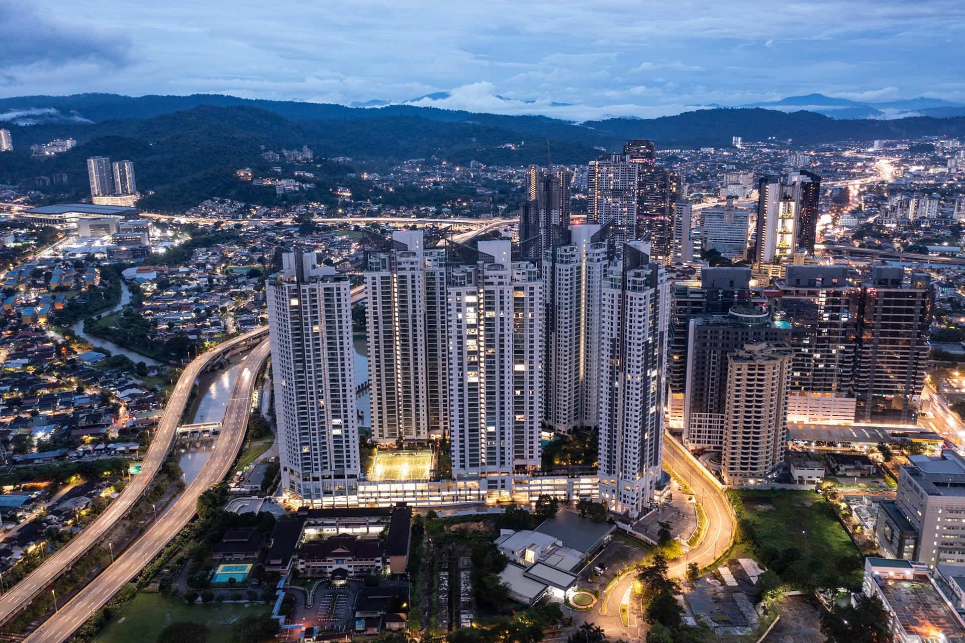 Dusk aerial view of the completed Cappella Embassy towers over Ampang Hilir and the AKLEH highway, Kuala Lumpur — photograph
