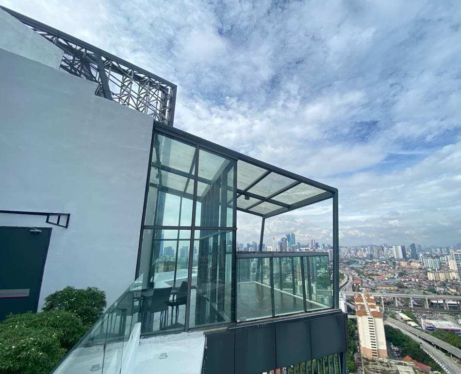 Glazed sky deck on Block E at Cappella Embassy looking across the Kuala Lumpur skyline — photograph