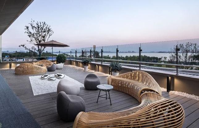 Sky terrace with rattan loungers at sunset, Block E Level 38A, Cappella Embassy — artist's impression