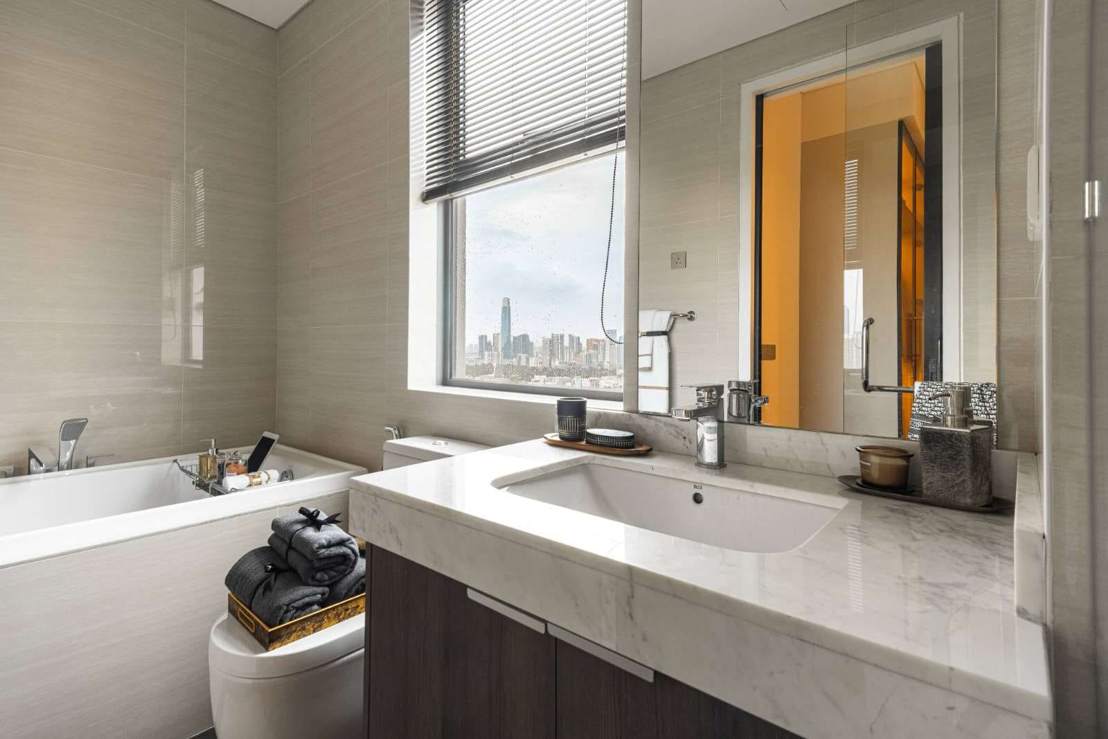 Type C show unit bathroom with stone vanity and walk-in shower at Cappella Embassy — show unit photograph