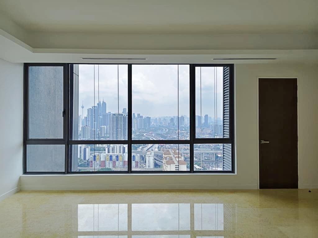 Vacant Type D1 residence at Cappella Embassy, 1,152 sq ft, window framing the Petronas Twin Towers — photograph of an actual unit in vacant-possession condition
