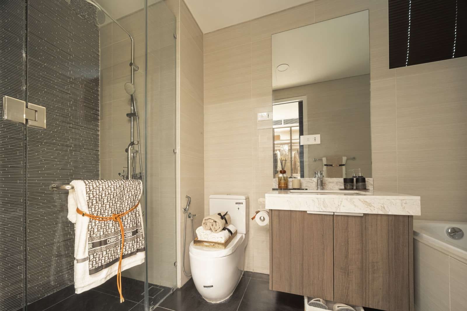 Type D2 show unit bathroom with stone finishes at Cappella Embassy — show unit photograph